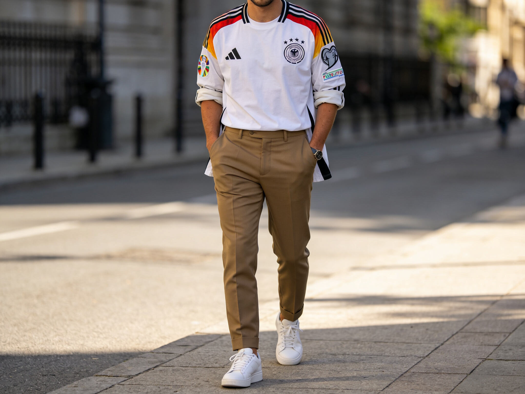 Style inspiration: A fan wearing a Euro 2024 style jersey paired with chino pants and clean sneakers for a casual, everyday streetwear look.