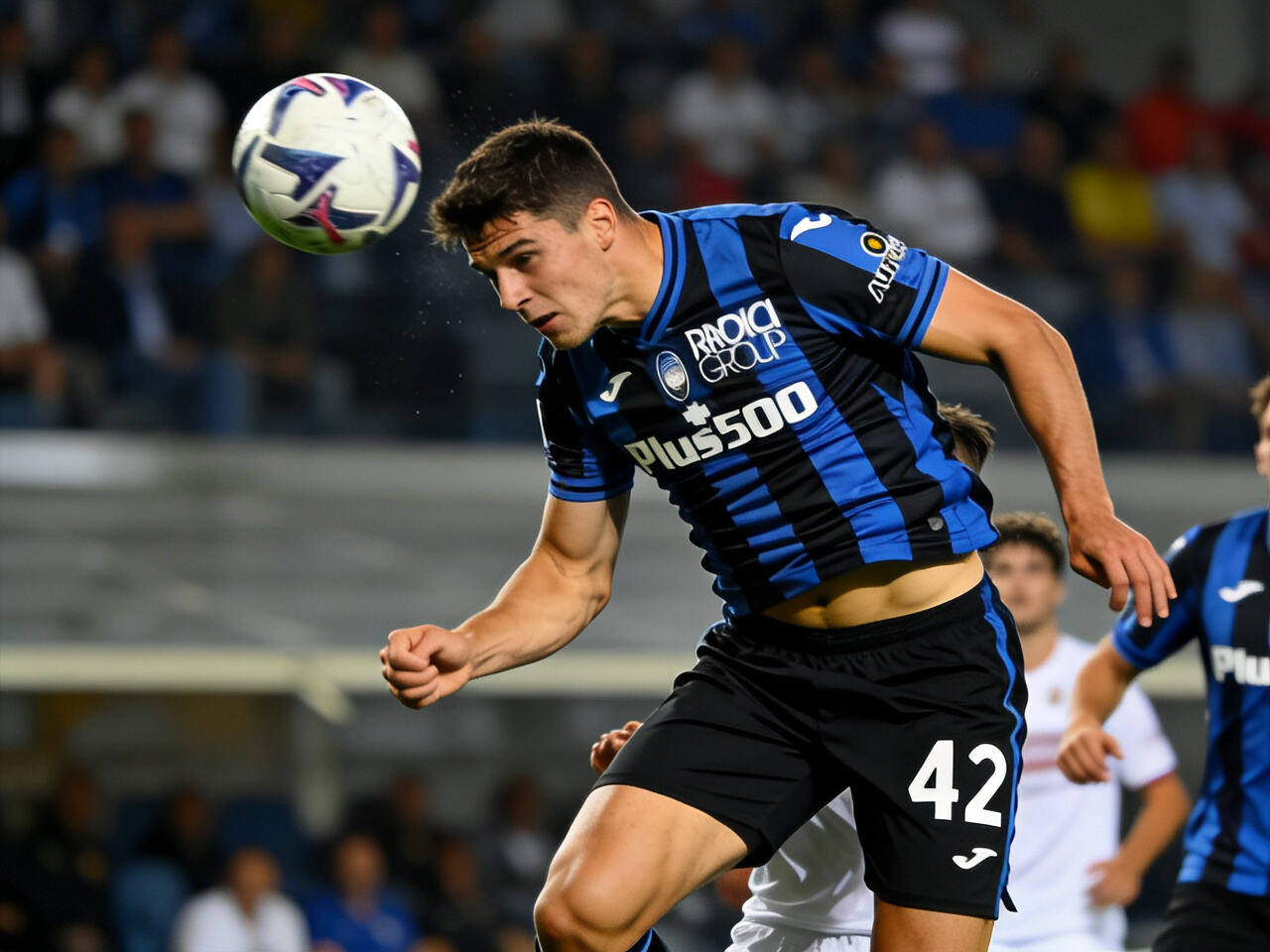 Giorgio Scalvini makes a decisive defensive intervention for Atalanta, displaying strength and the iconic #42 on his jersey. The modern Italian defender in action.