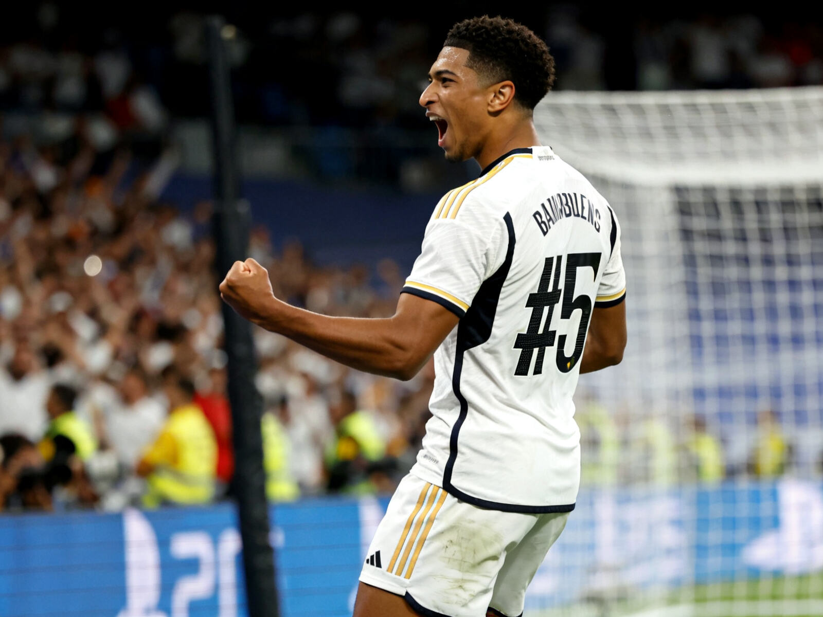 Jude Bellingham shows his iconic celebration after scoring for Real Madrid, wearing the club&lsquo;s iconic white 2024 home jersey with the number 5. A must-have kit for fans.